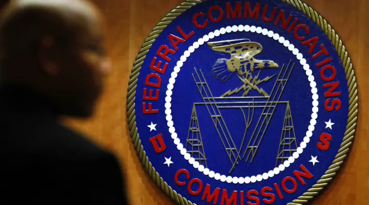 FILE- This Dec. 14, 2017, file photo, shows the seal of the Federal Communications Commission (FCC) before a meeting in Washington.  Congressional leaders and a media accountability organization are urging the Federal Communications Commission to examine how policy decisions have disparately harmed Black people and other communities of color, according to a letter sent Tuesday, June 29, 2021, to the acting FCC chair.  (AP Photo/Jacquelyn Martin, File)