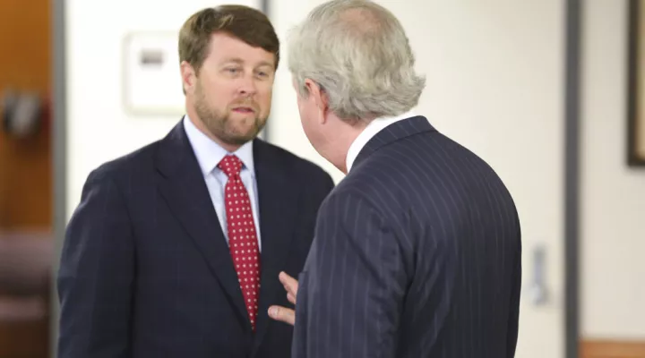 Former South Carolina Rep. and former U.S. Attorney in the state Peter McCoy, left, talks to Sen. Dick Harpootlian, D-Columbia, before a Senate Judiciary Committee hearing on his nomination to be chairman of the board that oversees state-owned utility Santee Cooper on Tuesday, June 29, 2021, in Columbia, S.C. Gov.Henry McMaster nominated McCoy for the post. (AP Photo/Jeffrey Collins)