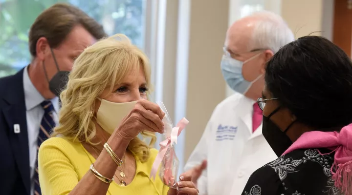 First Lady Jill Biden, left, presents pink ribbon cookies in honor of Breast Cancer Awareness Month to Dr. Marvella Ford, left, during a tour of the MUSC Hollings Cancer Center on Monday, Oct. 25, 2021, in Charleston, S.C. (AP Photo/Meg Kinnard)