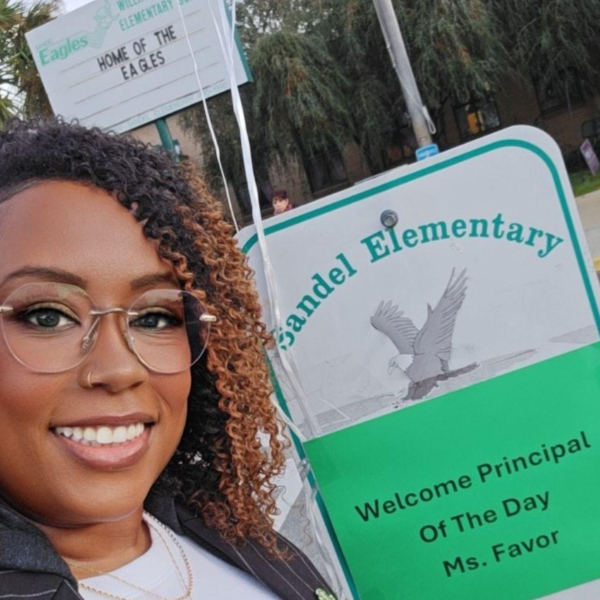 photo of Raven Favor as Principal of the Day in front of W.S. Sandel Elementary