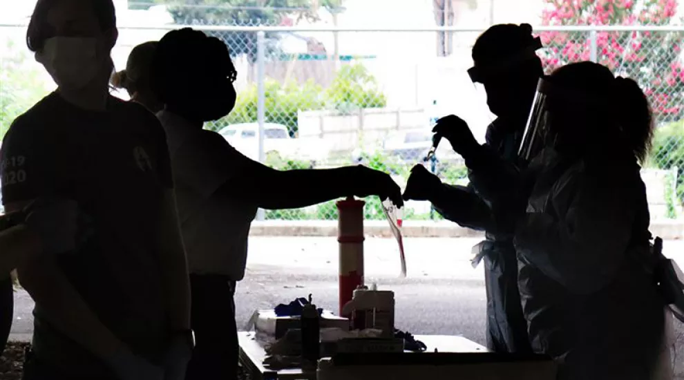 Healthcare workers collect samples at a drive-in testing site in Columbia, SC, on August 11, 2020.