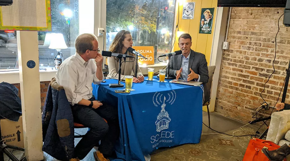 Gavin Jackson (r) speaks with Jamie Lovegrove (l) and Maayan Schechter at Growler Haus in Spartanburg, SC