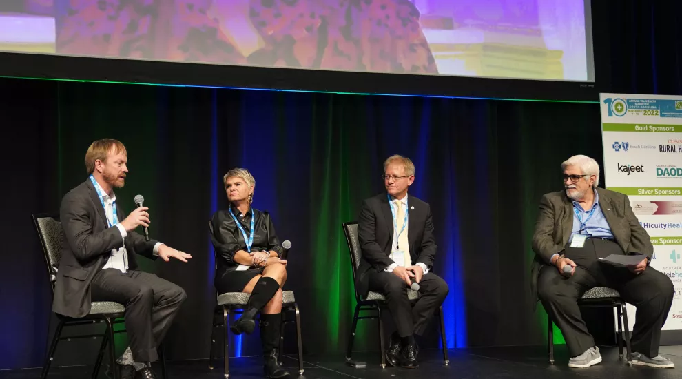 James McElligott, MD, MSCR, from left, Kathy Schwarting, MHA, Jim Stritzinger, and Rick Foster, MD, discuss digital solutions to make healthcare more accessible during the 10th Annual Telehealth Summit of South Carolina at the Charleston Gaillard Center in November.