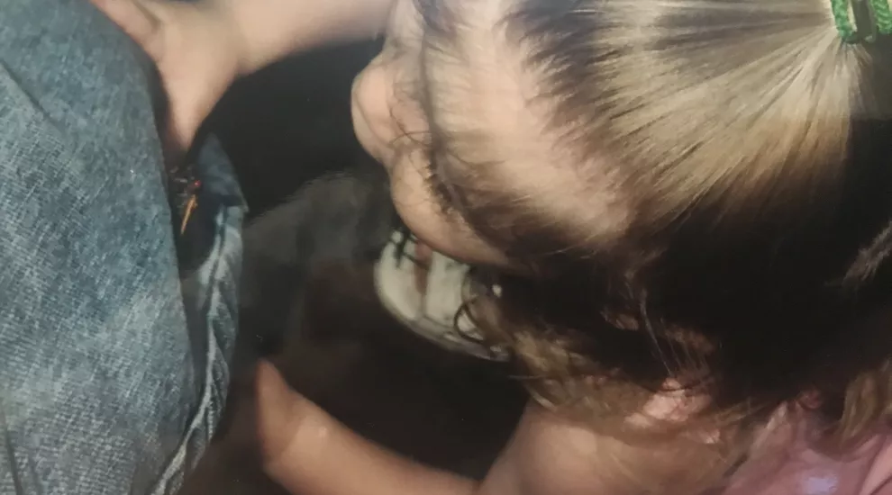 young girl looking at cicada