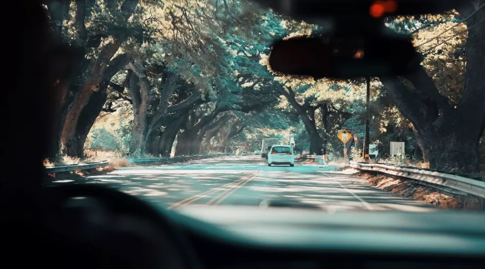 picture of a road as seen through a car's front window