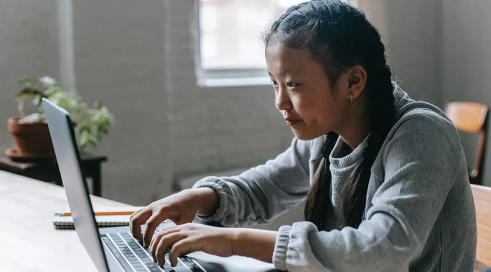 High school girl using laptop