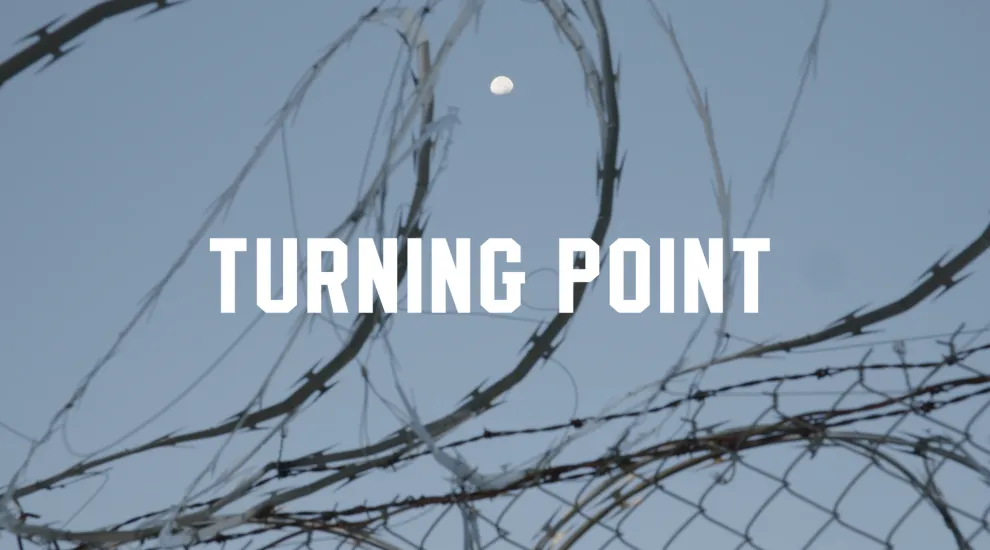 title turning point displayed with barbed wire fence in background