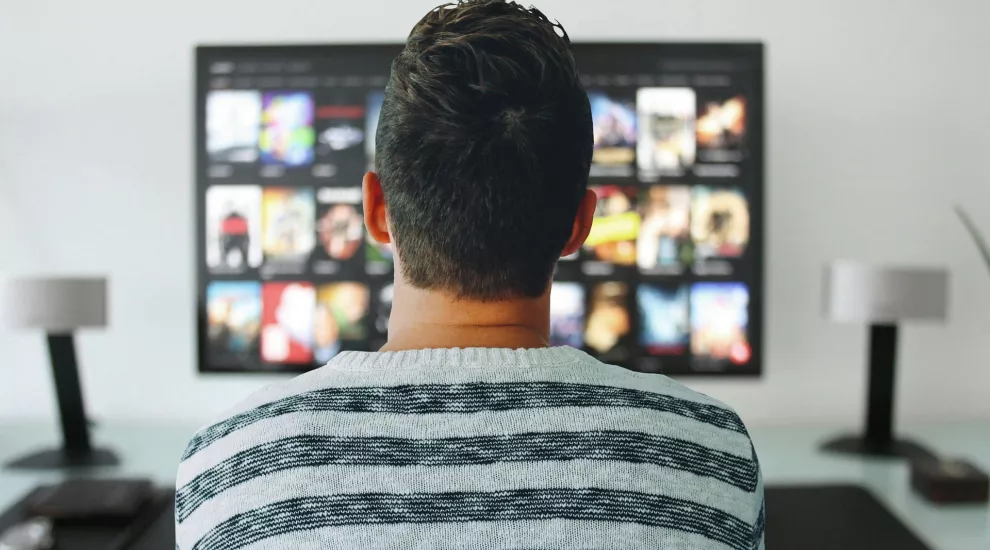 Man stares at media on a screen