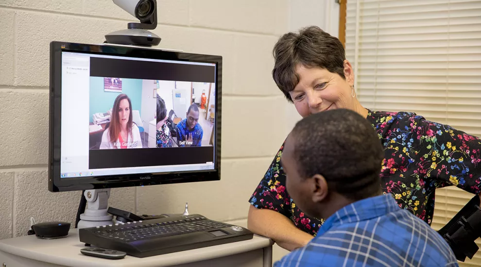 Nurse practitioner Kelli Garber consults with a patient through telehealth at C.E. Murray High School in Williamsburg County.