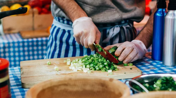 File photo of chef's hands cutting green onions