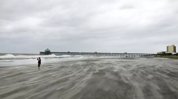 The scene from Folly Beach as wind from Hurricane Irma whips sand and waves on Sept. 10, 2017.