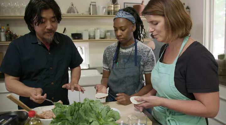Chef Ed Lee shows chefs Ashleigh Shanti and Vivian Howard how to make dumplings.