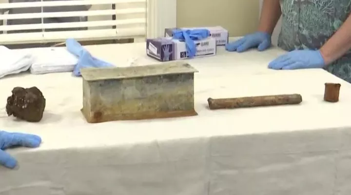 A rusty cannon ball and three tins found inside time capsule buried beneath the John C. Calhoun monument that once stood in Charleston's Marion Square.  The stone capsule is thought to have been buried during the 1850s.  It was opened February 25, 2021.