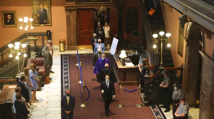 South Carolina senators walk across the Statehouse lobby for a joint session with the House on Wednesday, May 5, 2021, in Columbia, S.C. Senators sat in the balcony for the joint session because of COVID-19 concerns. (AP Photo/Jeffrey Collins)