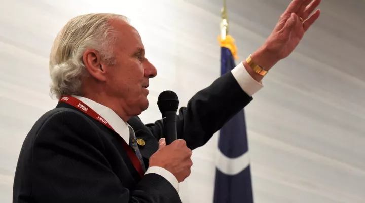 South Carolina Gov. Henry McMaster waves to his wife, Peggy, as he speaks during the Richland County GOP convention on Friday, April 30, 2021, in Columbia, S.C. (AP Photo/Meg Kinnard)