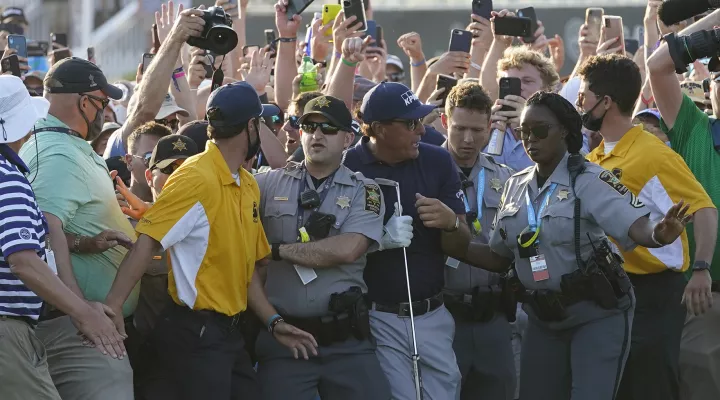 Phil Mickelson tries to get through the crowd during the final round at the PGA Championship golf tournament on the Ocean Course, Sunday, May 23, 2021, in Kiawah Island, S.C. (AP Photo/Matt York)