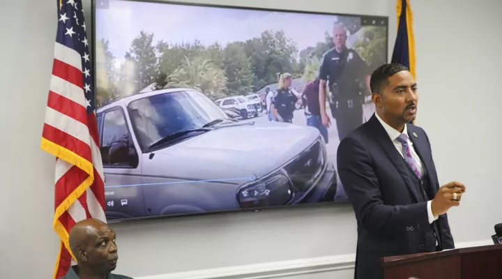 Attorney Justin Bamberg, right, speaks and his client Clarence Gailyard, left, listens, after Bamberg showed body camera video of an officer stomping Gailyard in the neck as Bamberg holds a news conference on Tuesday, Aug. 3, 2021 in Orangeburg, South Carolina. Orangeburg Public Safety officer David Lance Dukes was fired and charged with a felony after the July 26 incident. 