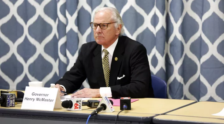 South Carolina Gov. Henry McMaster looks at data about the COVID-19 spread in the Kershaw County School District during a discussion with school officials at Camden Elementary School on Wednesday Sept. 15, 2021, in Camden, S.C. Nurses, principals and school board members were part of the roundtable discussion. (AP Photo/Jeffrey Collins)