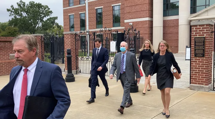 Former SCANA CEO Kevin Marsh, center, walks out of a courtroom with his lawyers after being sentenced to two years in prison for lying and deceiving the public about the progress of a pair of nuclear reactors in South Carolina that were never finished and wasted billions of dollars on Thursday, Oct. 7, in Columbia, S.C. Marsh also has pleaded guilty in state charges in the case. (AP Photo/Jeffrey Collins)