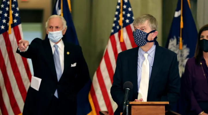 FILE - South Carolina Department of Health and Environmental Control Director Edward Simmer, right, and Gov. Henry McMaster, left, discuss the state opening up vaccines for more people at a news conference on Tuesday, March 2, 2021, in Columbia, S.C.   McMaster says, Wednesday, Jan. 5, 2022,  there is no need to close schools and businesses because of the omicron variant of COVID-19.  (AP Photo/Jeffrey Collins, File)