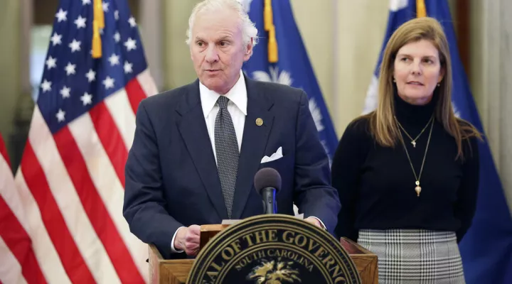 FILE - South Carolina Gov, Henry McMaster, left, releases his budget proposal along with Lt. Gov. Pamela Evette, right, on Monday, Jan. 10, 2022, in Columbia, S.C. McMaster's spending proposal includes an income tax cut more than $1 billion for roads and rural water and sewer improvements.(AP Photo/Jeffrey Collins)