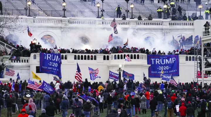 FILE - Violent protesters, loyal to President Donald Trump, storm the Capitol in Washington on Jan. 6, 2021. A man who identified himself as a believer in the QAnon conspiracy theory was sentenced on Wednesday, Jan. 26, 2022, to three years and eight months in prison for assaulting police officers at the Capitol during last year's riot. Nicholas Languerand called himself a patriot, but the judge who sentenced him said the rioters who invaded the Capitol on Jan. 6, 2021, don't deserve that description. (AP …