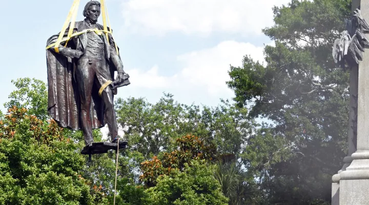 FILE - A statue of former U.S. vice president and slavery advocate John C. Calhoun is raised by crews after its removal, June 24, 2020, in Charleston, S.C. The statue still hasn't found a new home and a lawsuit says it was illegally removed and should be put back up. Charleston leaders and officials at South Carolina’s State Museum announced Monday, Feb. 7, 2022 they have started talking about a deal bringing the statue to the museum's Columbia site, but there are plenty of details to hammer out and Charle…