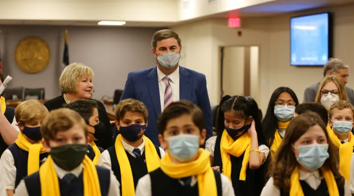 South Carolina House Ways and Means Chairman Murrell Smith, R-Sumter, poses with children from a Florence Catholic school on Tuesday, Feb. 8, 2022, in Columbia, S.C. The students were there to support a school choice bill. (AP Photo/Jeffrey Collins)