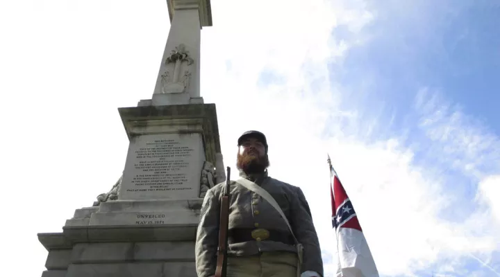 FILE - In this July 10, 2017 file photo, Cameron Maynard stands at attention by the monument to Confederate soldiers at the South Carolina Statehouse in Columbia, S.C.  A bill giving state employees in South Carolina a floating holiday to replace Confederate Memorial Day is heading to the Senate floor. The bill started as a proposal to add the Juneteenth celebration on June 19 as a new state holiday. (AP Photo/Jeffrey Collins)