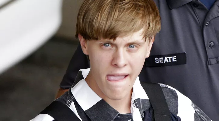 FILE - In this June 18, 2015, file photo, Charleston, S.C., shooting suspect Dylann Storm Roof is escorted from the Cleveland County Courthouse in Shelby, N.C. Attorneys for the convicted Charleston church shooter have asked the U.S. Supreme Court to decide how to handle disagreements over mental illness-related evidence between capital defendants and their attorneys. (AP Photo/Chuck Burton, File)