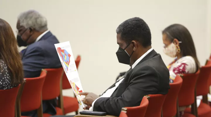  FILE - South Carolina Rep. Jerry Govan, D-Orangeburg, looks over a map during a House redistricting committee public hearing on Wednesday, Nov. 10, 2021, in Columbia, S.C. Govan was put into a district with another incumbent in the proposed House map.