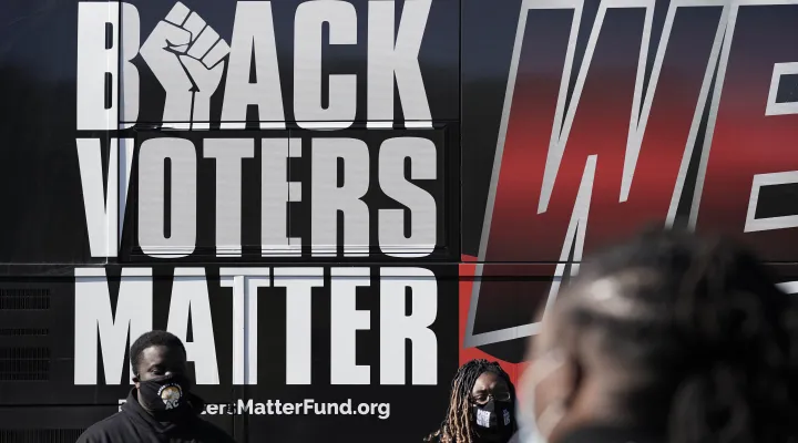 FILE - Supporters of Black Voters Matter gather at a polling site at the Graham Civic Center in Graham, N.C., Tuesday, Nov. 3, 2020. 
